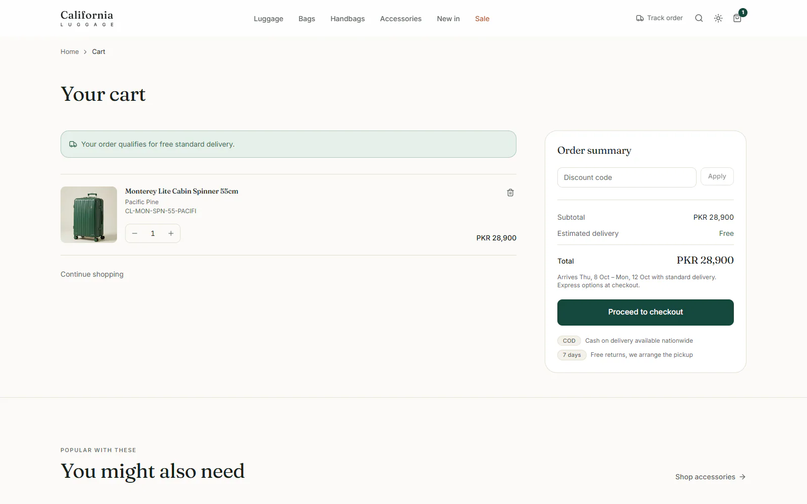 Cart with one suitcase, a note that the order qualifies for free delivery, and an order summary