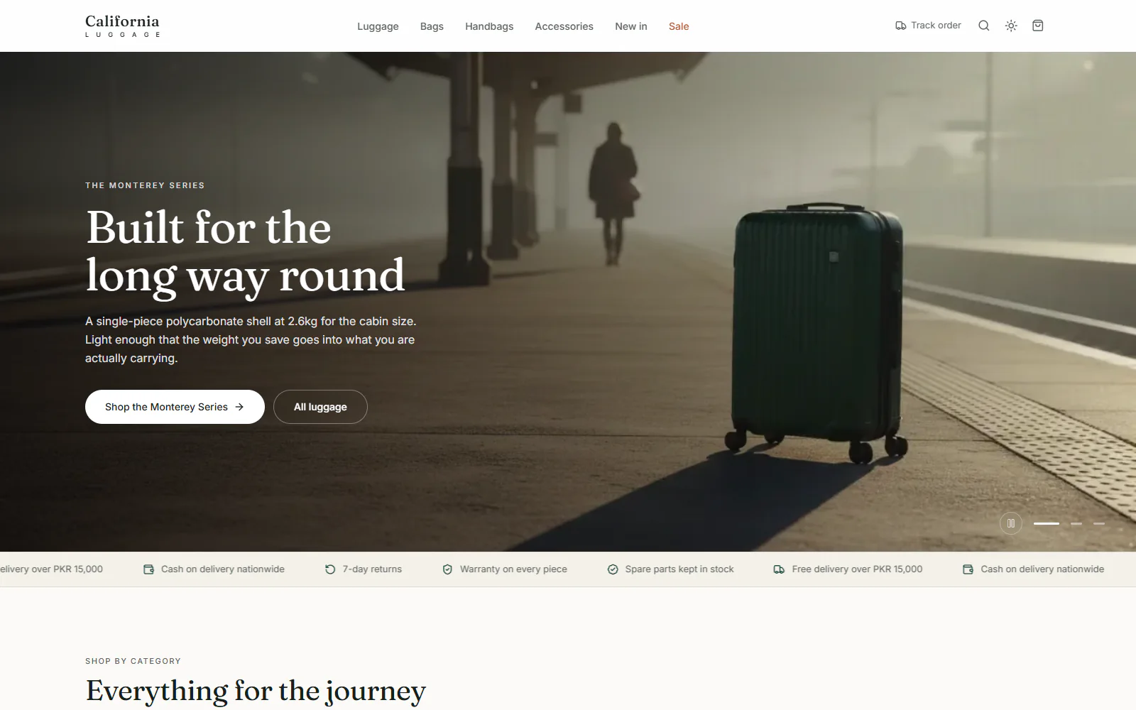 Store homepage: a green cabin suitcase on a station platform under the headline Built for the long way round